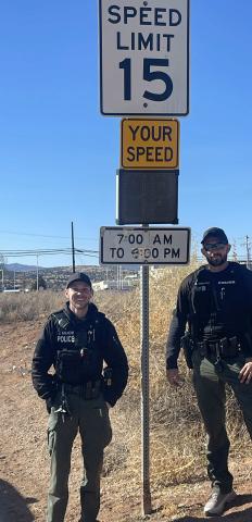 Milan Police Officers Justin Alheim and Nicolas Candelaria stand next to the new traffic sign in the Village of Milan. This new piece of technology is expected to slow traffic in areas where speeders are reported and frequent. By combining their on-the-ground efforts with tech, Milan Police Department is finding ways to keep the community safe and secure. Courtesy Photo