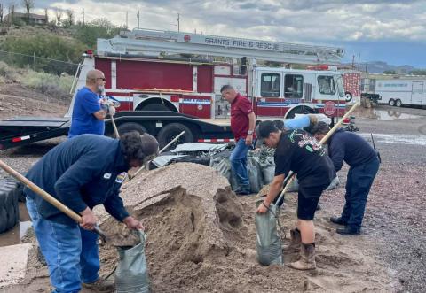 Courtesy Photo Residents in Cibola County came together to shovel dirt and sand into bags, hoping to build barriers that would prevent water from entering homes during the most recent monsoon rains. Grants Fire and Rescue, Milan Fire Department, and the Cibola Roads Department worked to get sandbags ready for residents across the county. GFR thanked residents who participated, and those who helped support their efforts, like 1912 Market on Santa Fe Avenue who took water and other snacks to the crews.