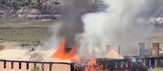 Flames and heavy smoke rise Saturday from a historic building at Fort Wingate east of Gallup. McKinley County fire crews fought the lightningcaused fire defensively because of the structure’s deteriorated condition and prevented it from spreading to neighboring buildings. The former Army barracks and boarding-school dormitory were considered a total loss. Courtesy Photo