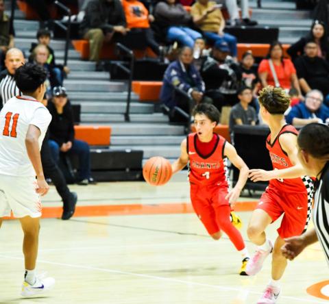 Joziah Ortega, 14, freshman point guard dribbles into the Gallup defense to run a play at a recent game in Gallup. The Pirates are 5-2 headed into the Bernalillo Tournament this weekend where they will face three 5A schools. Franklin Romero - CC