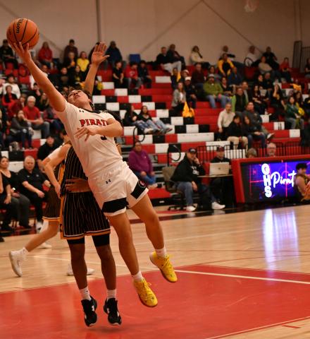Junior point guard, Tristin Fernandez, 5, drives it in for a bucket against district rival St. Pius at a recent home game. The Pirates (12-13, 3-4) are aiming for a third place showing in the powerful 4A district 5. They are between the number one team in the state, St. Pius, and the 6th ranked team in the state, the Highland Hornets. The Lady Pirates are currently 10-15, 3-5 and both teams will play the last game of the regular season on Tuesday, February 18. Franklin Romero - CC