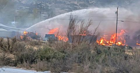 Flames engulf multiple homes Sunday evening in the Balsam/Sage area of Grants as firefighters battle the fast-moving Alamo Fire. The blaze destroyed six homes and injured two firefighters before it was fully extinguished later that night. Photo by Patrick Gonzales