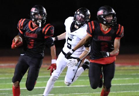 Pirates Ahoy! The Pirates chalked up a 28-6 win against district rival, the Aztec Tigers (0-5,0-3) this past Friday at the Port of the Pirates. 'I am pleased with how we played against Aztec,'I am pleased with how we played against Aztec,' said GHS Head Football Coach Steve Brown. In this photo Boudy Melonas, 3, hustles down the field as Cardeno Chavez, 2 blocks for him. Franklin Romero - CC