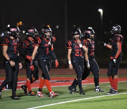 Grants Pirates huddle up during a Friday night showdown. The Pirates, currently 3-3 overall and 2-1 in district play, are preparing to face the Taos Tigers in a key district matchup on October 11 at the Port of the Pirates. Franklin Romero - CC