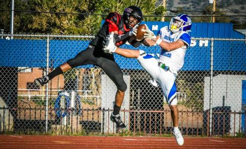 Franklin Romero - CC 2 vs 2 ! Coudy Melonas, 2, of the GHS Pirates football team battles with Omar Loya, 2, from Dexter High School. The pass was ruled incomplete. The Pirates had a challenging game with the Demons and when the Friday night lights turned off, the Demons won the night with a 34-12 victory over the Pirates. Next up for the Pirates will be a road trip to Espanola Valley (3-0).