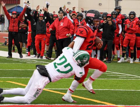 Senior Andres Lazos (22) powers through a tackle to score a rushing touchdown, igniting celebration from teammates, coaches, and fans on the sideline. The Pirates defeated Moriarty 19–6 in the 2024 homecoming game—one of the season’s most memorable moments. Franklin Romero - CC