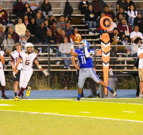 Hawk running back Marshall Deutsawe,11, with a catch and followed by a touchdown in last week's contest against rival Santa Fe Indian. The Hawks defeated Santa Fe Indian by a score of 52-0 and advance to 2-1. They will host Hatch Valley (21) this Thursday at 'The Nest' at 6 pm Courtesy Photo