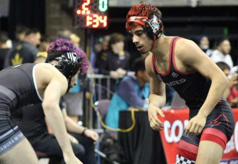 Manuel Gonzales, a junior, wrestles at that 121-pound weight class sizes up his opponent before he begins his match. Franklin Romero - CC