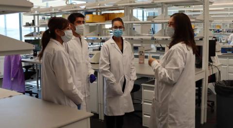 From right to left is Roslynd Archuleta, Kayla Lopez, Seth Torres, Minuet Whitney (all Forensic Scientists in the DNA Unit) discuss findings in the laboratory. Photo by DPS Media Relations Unit – Curtis Althaus and Payton Santillanes.