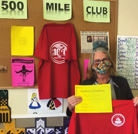 Featured is a proud Lezlie Smith and what she won for completing 100 miles of swimming — a certificate and a T-shirt. Kylie Garcia - CC