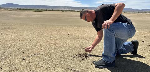 Mayor Erik Garcia examines the dry, compacted ground at Coyote del Malpais Golf Course in Grants during a recent tour of the property. The area behind him is the course’s driving range, where city officials say long-term water, soil and infrastructure problems have contributed to the facility’s decline. Diego Lopez - CC