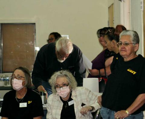 Jennifer McCall, center foreground, senior RECAparalegal for J. Keith Killian in Durango, Colo., listens to questions from the Post-'71 Uranium Workers Committee audience during anApril meeting in Grants, N.M. She is accompanied by Diana Brophy, left, and Liz Lucero, right. Photo by Kathy Helms