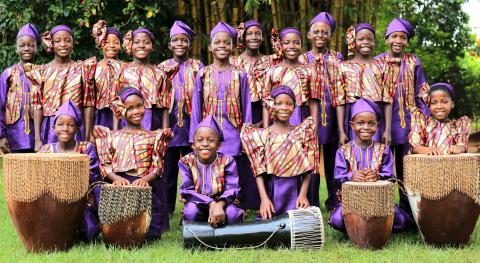 Courtesy Photo Members of the African Children’s Choir pose in their vibrant traditional attire with instruments that will accompany their uplifting performance tonight at First Baptist Church in Grants. The choir, celebrating its 40th anniversary, aims to inspire hope and raise funds for education through their music and message of resilience.