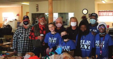 Community members gathered at the Grants Community Center to hand out food bags to celebrate Martin Luther King day this past Monday. From left front row, Faith Woods Aspen Woods, Dorthey Pouges, and Angela woods. Back row from left, Bill Binion, Jabez Cruz, Lea Cruz, Jackye Scyrkles, and Robert Pouges. Scott Ford -CC