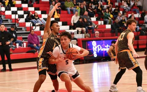 Tristin Fernandez, 5, drives it in at a recent home game. The Pirates ended their season 13-15 and 4-4 after a 72-57 loss to the Academy Chargers last Saturday in the first round of the Nusenda 4A state boys’ basketball tournament. Franklin Romero - CC