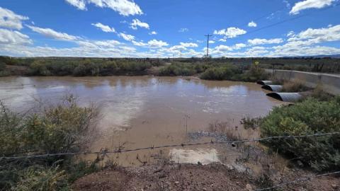 Waters from Bluewater Lake flow into this small reservoir in Bluewater Village, which receives releases for agricultural use downstream. As of 2 p.m. Tuesday, Oct. 14, water levels were visibly high following recent rainfall and continued lake outflows, cresting on the bridge connecting Route 66 and Roberts Road. PHOTO by Eric Brinn