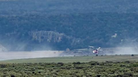 A helicopter dips into water from Bluewater Lake on Aug. 10 to assist firefighting efforts on the Four Mile Fire in the Zuni Mountains near Jamestown. Photo by Kathy Helms
