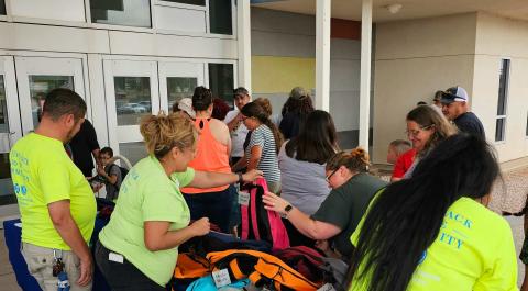 Milan Elementary students select backpacks. Courtesy Photo