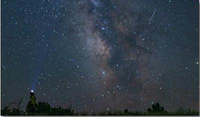A stargazer looks toward the heart of the Milky Way at El Malpais National Monument, where pristine dark skies offer a window into the cosmos. April Astronomy Month programs invite the public to experience the wonders of the night sky with ranger-led events throughout the month. Courtesy Photo