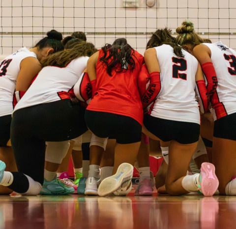 The Lady Pirates gather in a team huddle between points during their match Photo by Jay Langford
